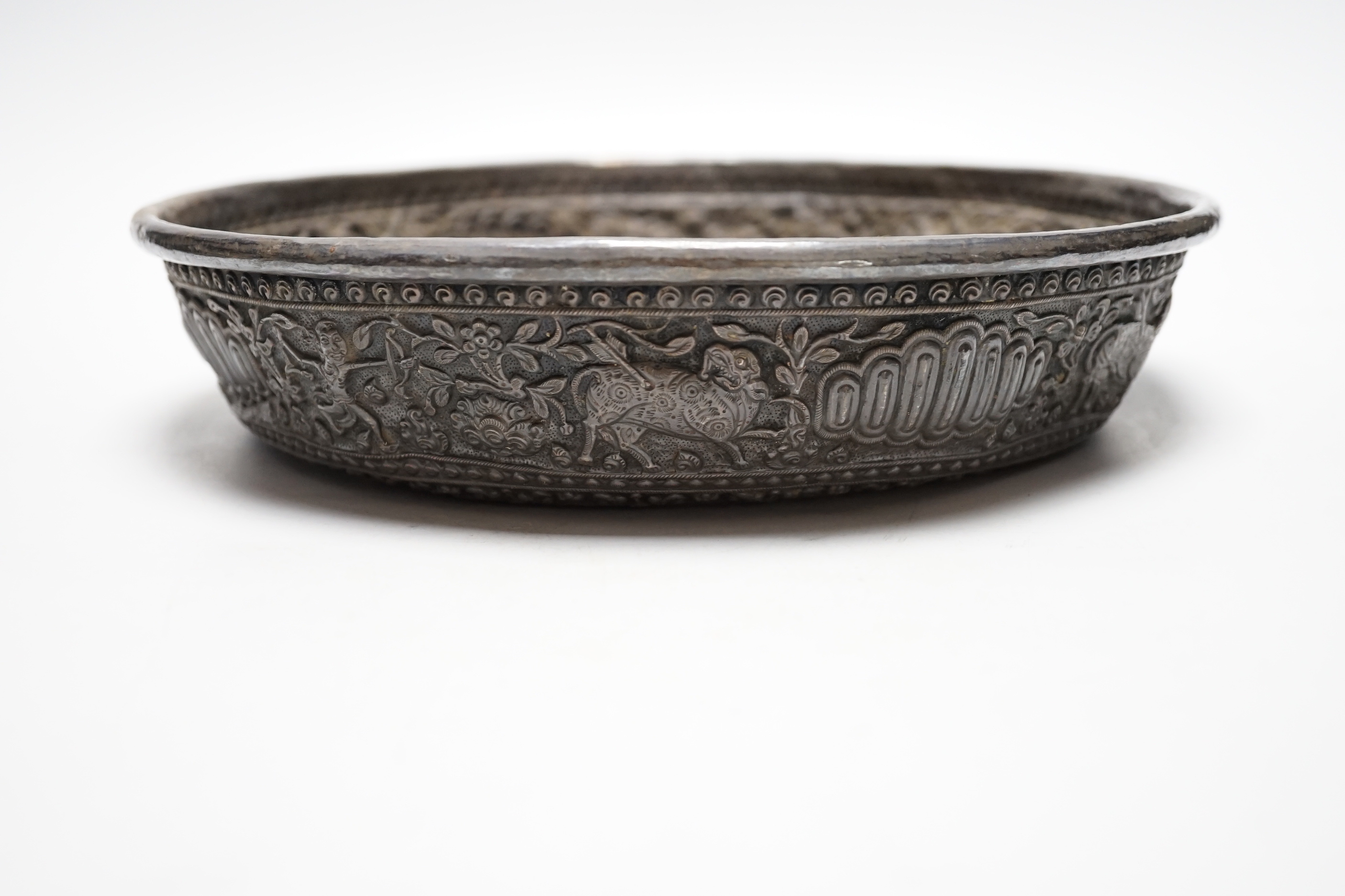 An Asian embossed white metal (tests as silver) shallow bowl, 25.2cm, 13.5oz.